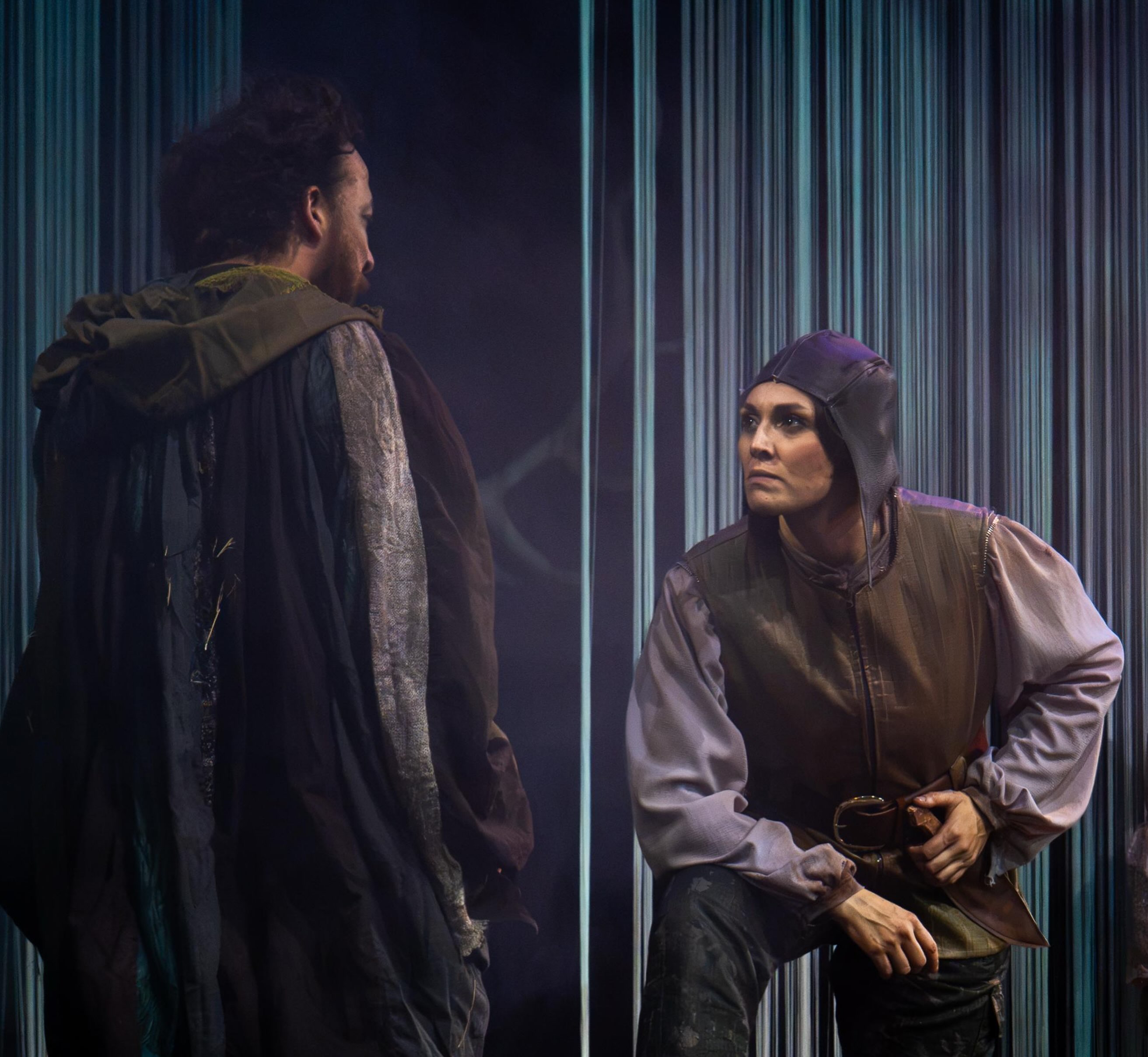 Encuentro entre dos personajes junto a los hilos de la escenografía